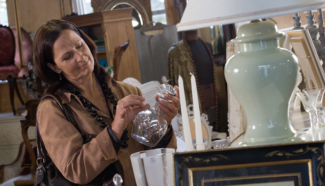 woman browsing home goods at an estate sale