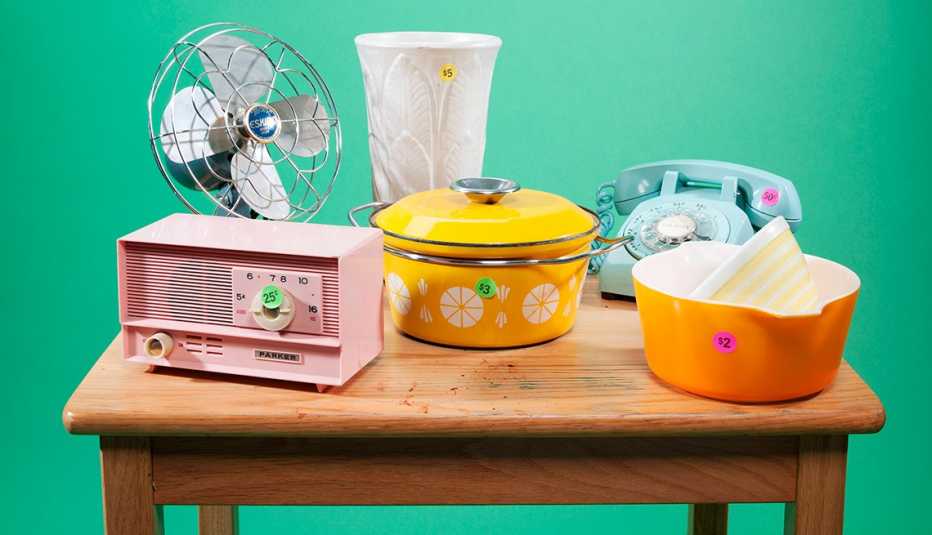 table of items you would find at estate sale such as cookware and small appliances 