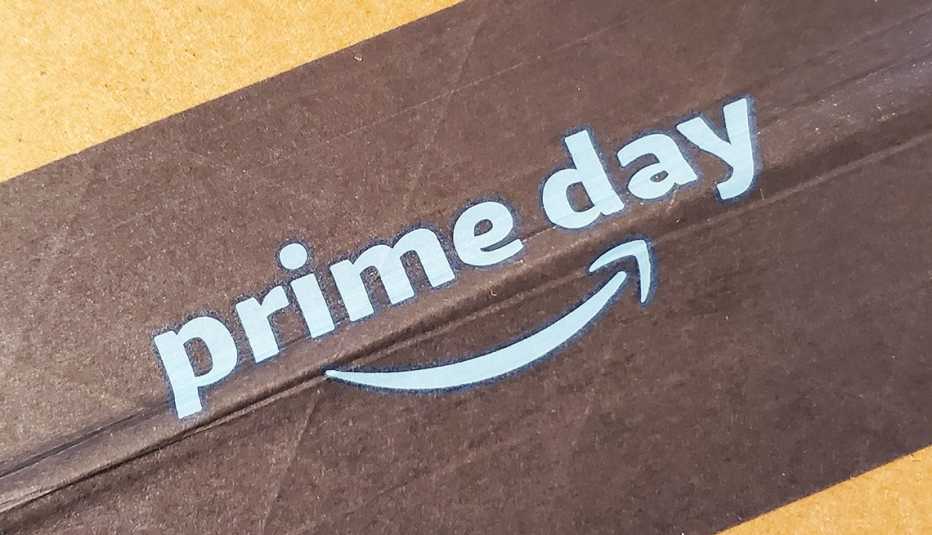 Close-up of a brown paper tape label that says "Amazon Prime Day" on a cardboard delivery box .