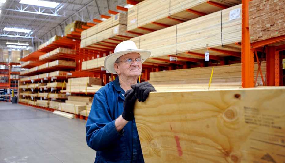 Man getting ready to purchase a piece of lumber at a Home Depot store 