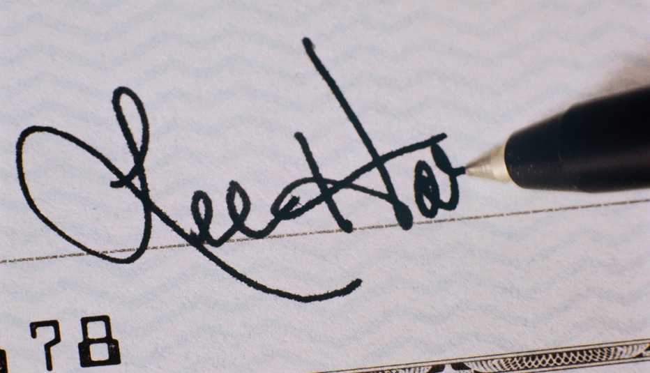 signing a check with a gel pen