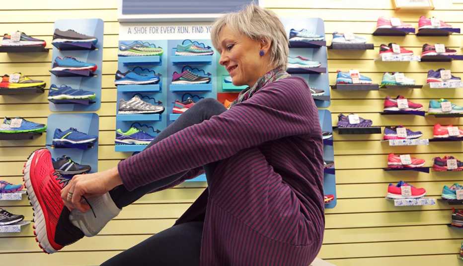 woman in athletic footwear store trying on running shoes
