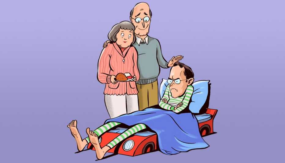 parents standing over their adult son who is in a too small race car bed