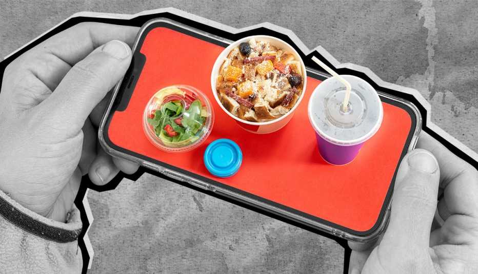 hand holding a phone with tiny food on it