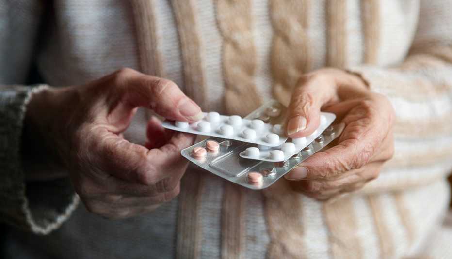 closeup of a person holding packaged pills