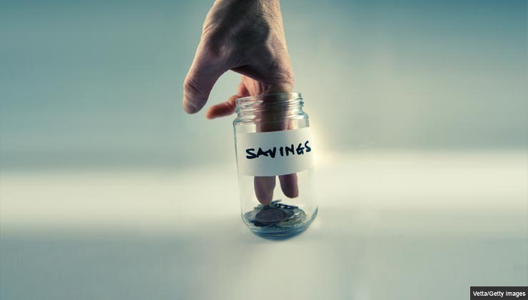 Should I save money or pay off debt?- fingers in the savings jar