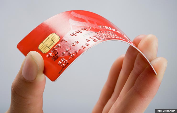 Person holding a credit card. Balance transfer offers usually aren't free. (Image Source/Alamy)