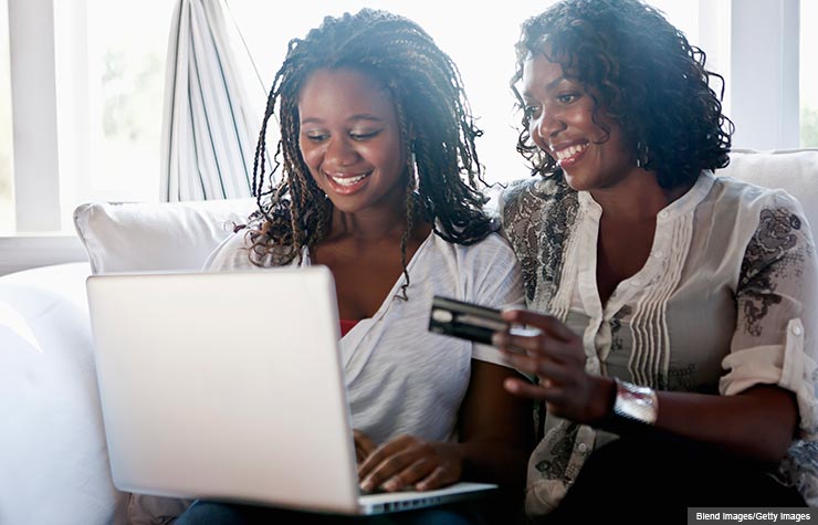 Mother and daughter shopping online with credit card, Help Your College Student to Develop Credit Card Smarts (Blend Images/Getty Images)