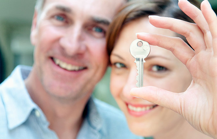 Woman holding a house key. Should you give your kids a mortgage?