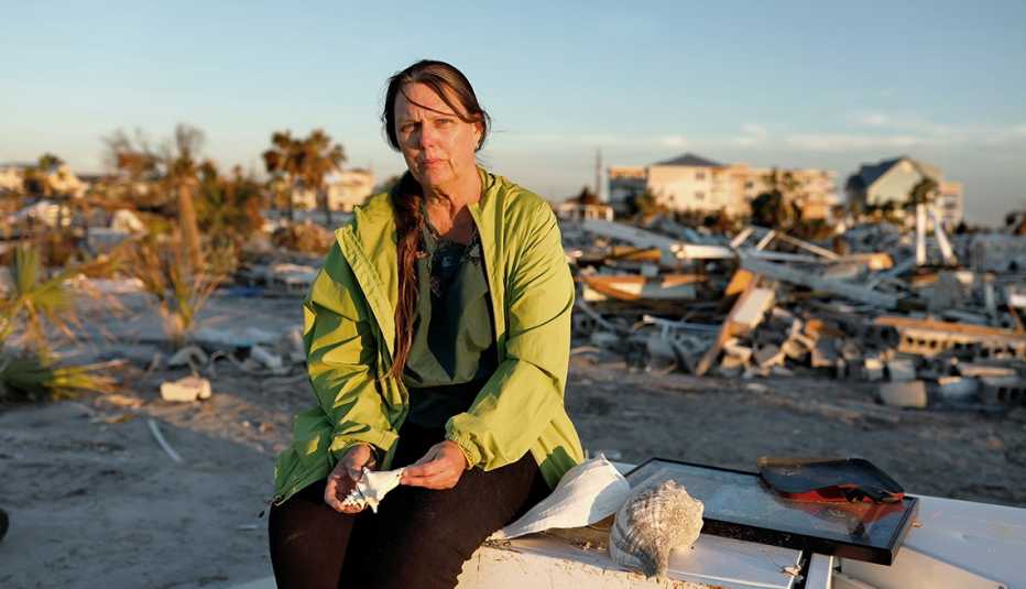 Secrest holds shells found where her home stood before Hurricane Michael.