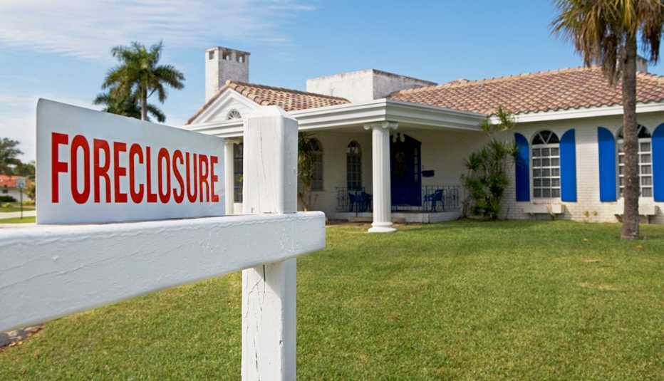 a house with a foreclosure sign in front of it