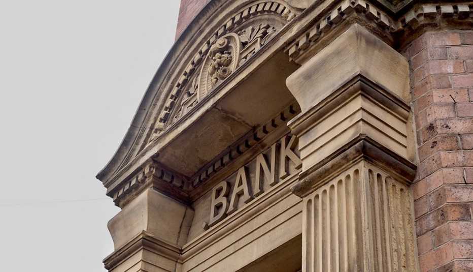 Bank sign carved on classic stone building