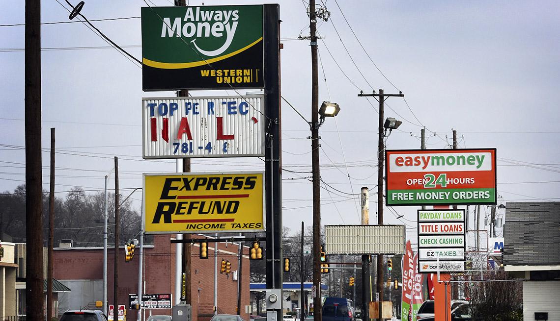 signs advertising short-term payday loans line a street in Birmingham, Alabama