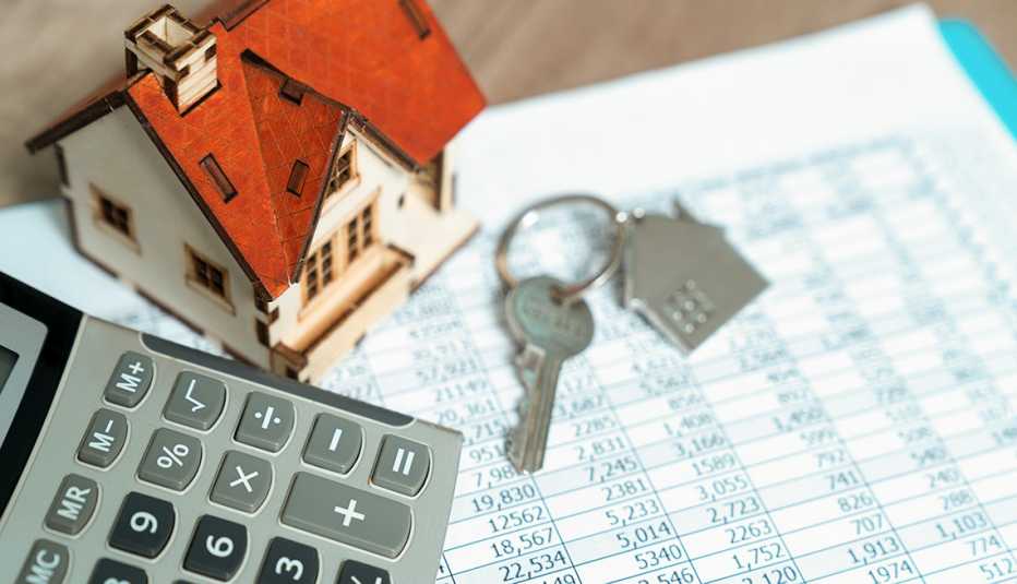 Image of money spreadsheet, calculator and house keys