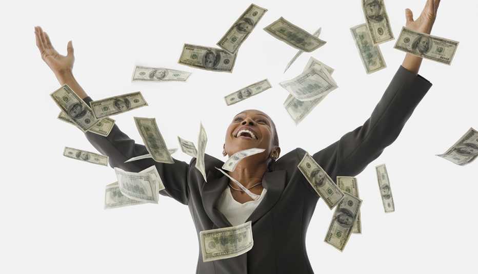 happy woman arms stretched out as money rains down 