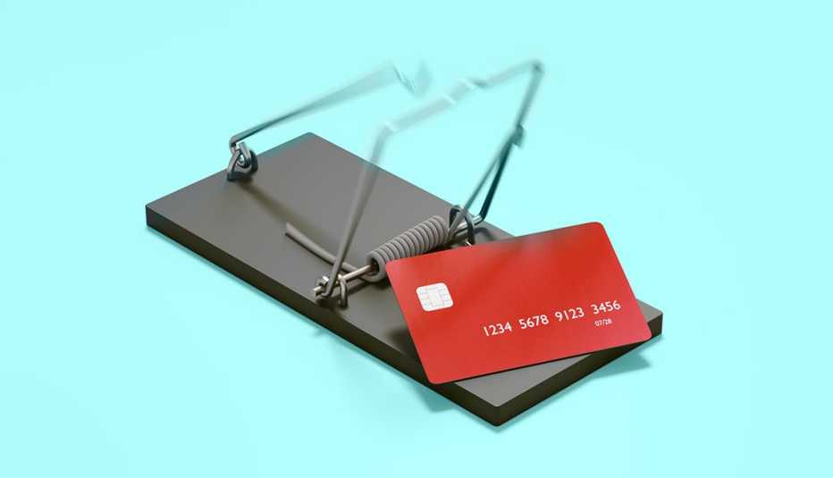 a red credit card in a black mousetrap over a light blue field