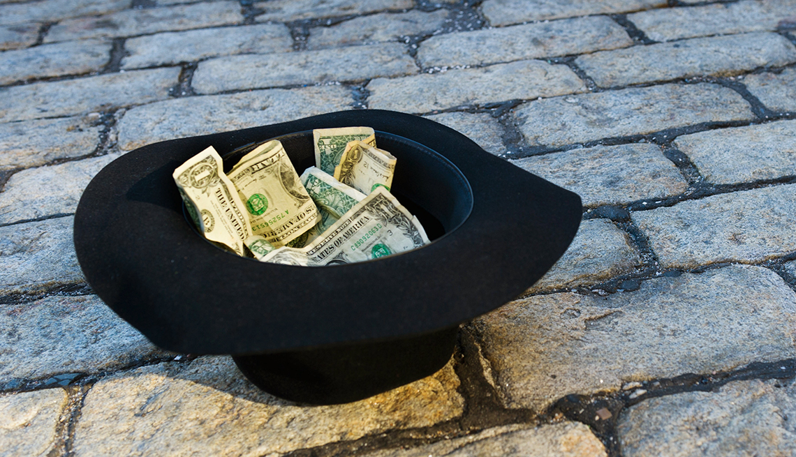 begger's hat with money inside