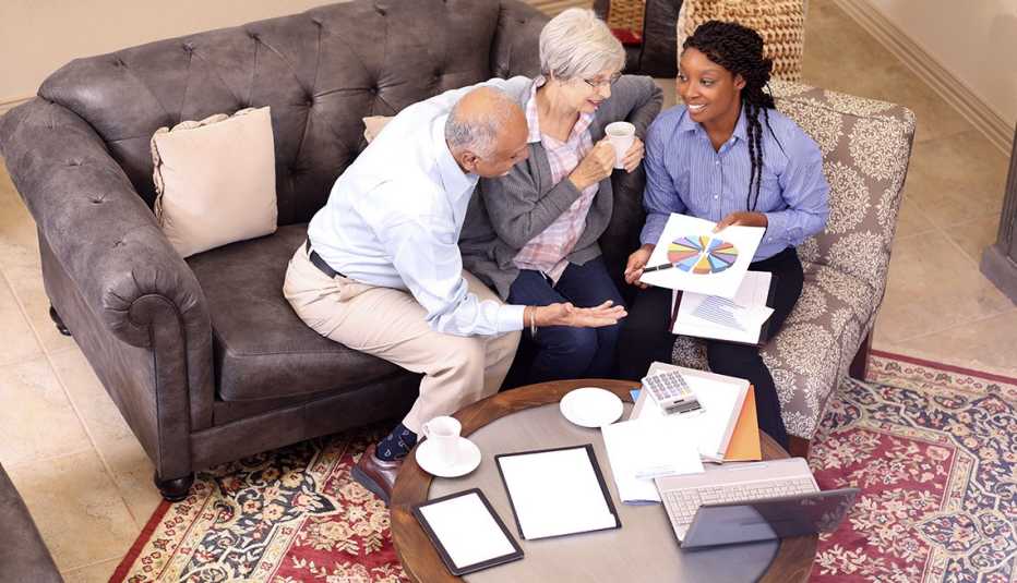 couple meeting with financial advisor in their living room