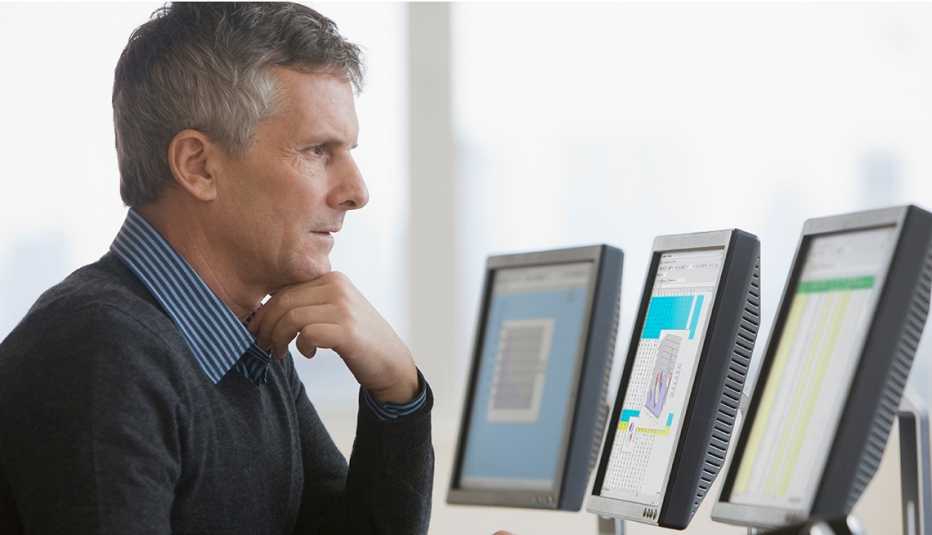 mature man looking concerned at computer screen