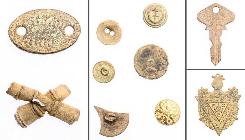 an assortment of metal items michael mccullough had found while metal detecting include a saddle strap guide coins from the eighteen and nineteen hundreds a key to a model t ford and a knights of pythias badge pin