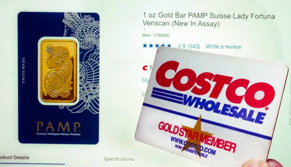 A Costco membership card is held in front of a store webpage that shows a one-ounce Gold Bar for sale.