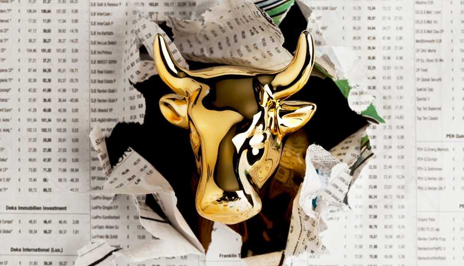 golden bull breaking through financial pages