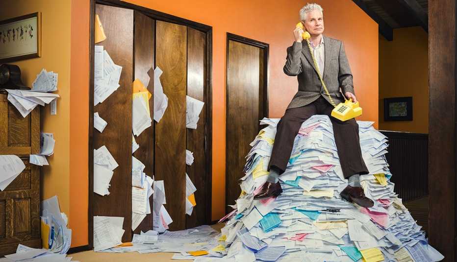What's Bugging You - Ron Burley sitting on the pile of paper on the phone