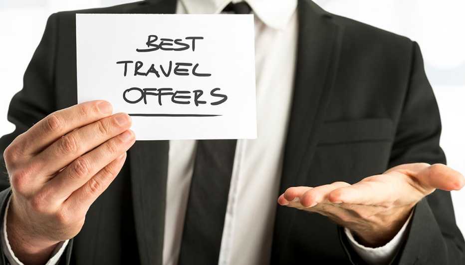 Man holding paper saying "Best travel offers"