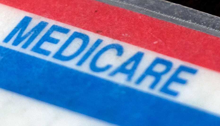 the word medicare on a white card with blue and red stripes