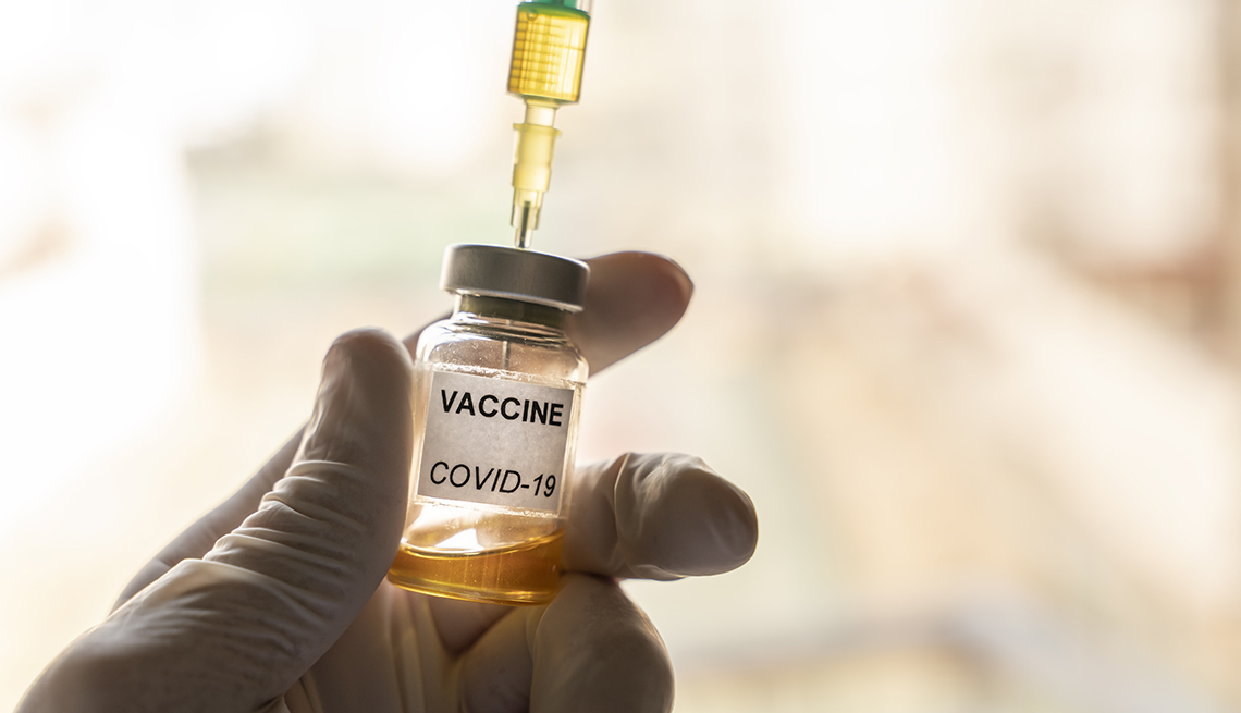 Coronavirus vaccine in a vial with a glove