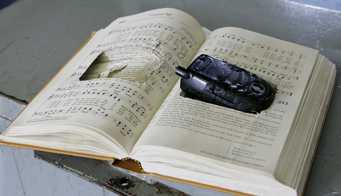 a prison contraband bible with the pages cut to hide a cell phone sits in a training room