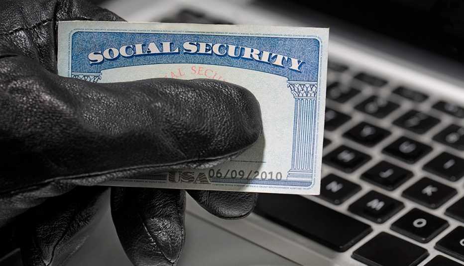 Thief holding a social security card.