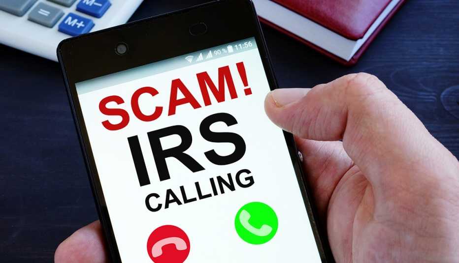 Hand is holding phone with IRS scam calls