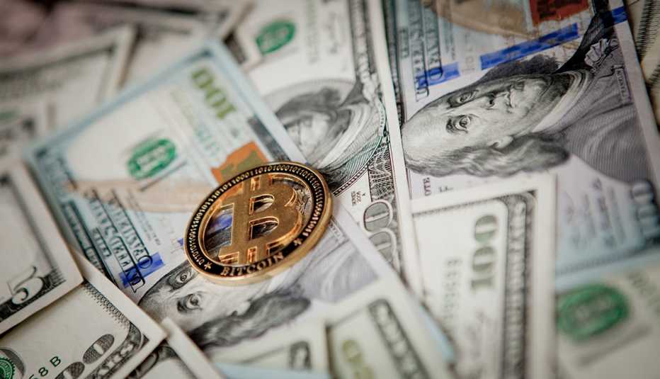 Golden Bitcoin on US dollar bills. Electronic money exchange concept.