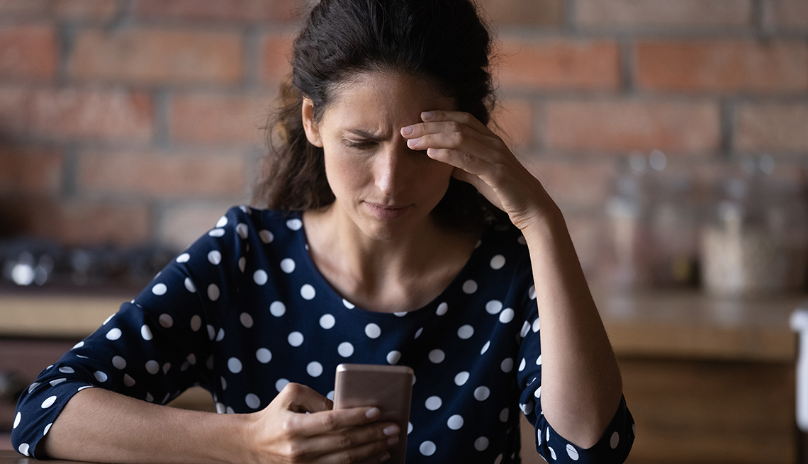 Worried woman having problems with mobile phone,