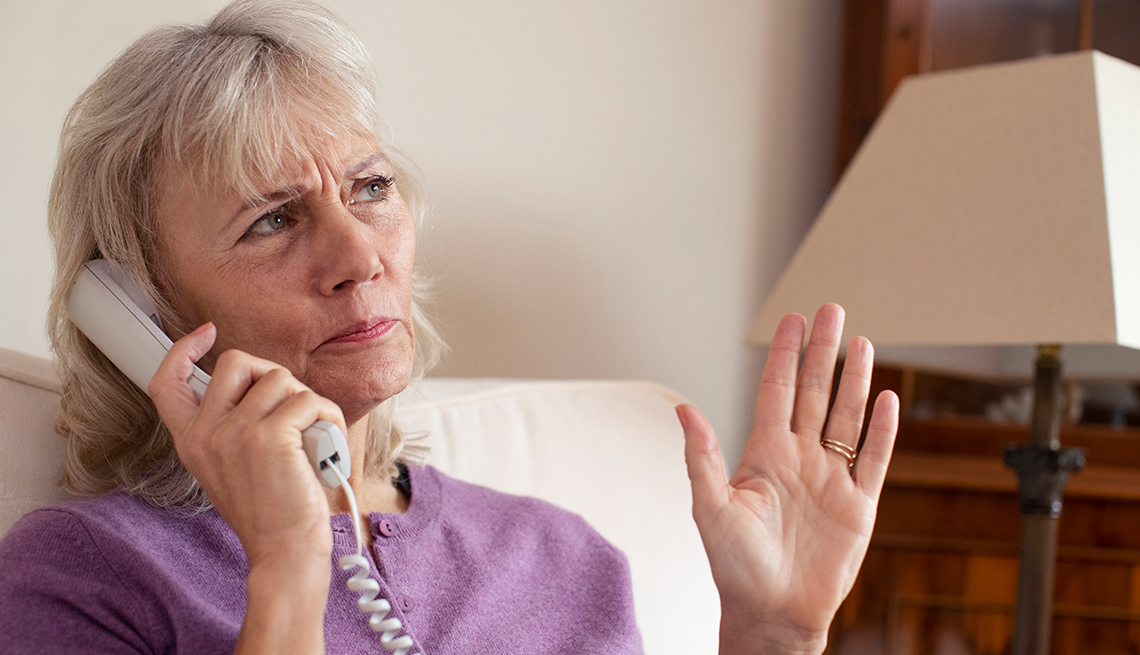 Woman receiving unwanted telephone call At Home