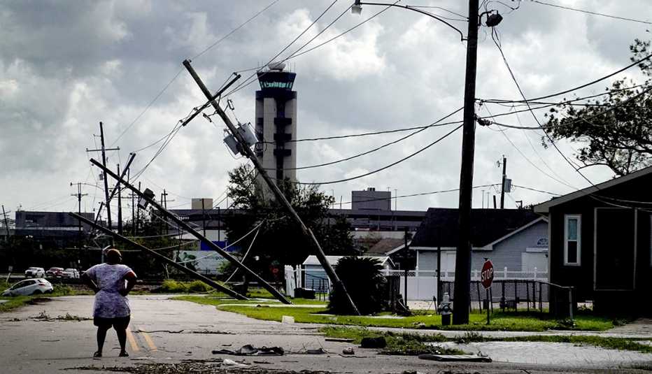 A woman looks over damage to a neighborhood caused by Hurricane Ida on August 30, 2021 in Kenner, Louisiana. Ida 