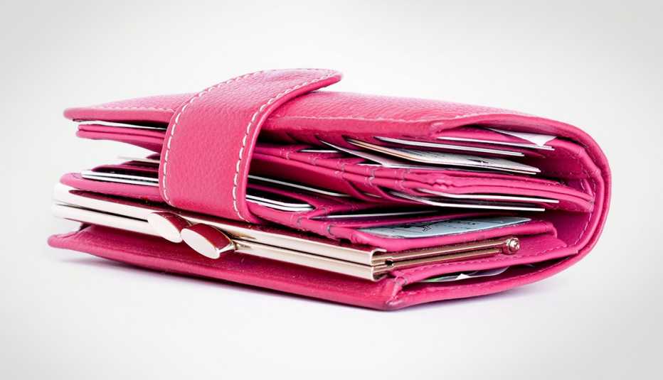 Folded women's pink leather wallet.