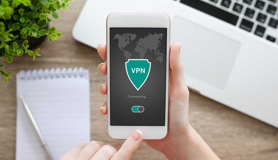 Woman holding phone with app vpn creation Internet protocols for protection private network