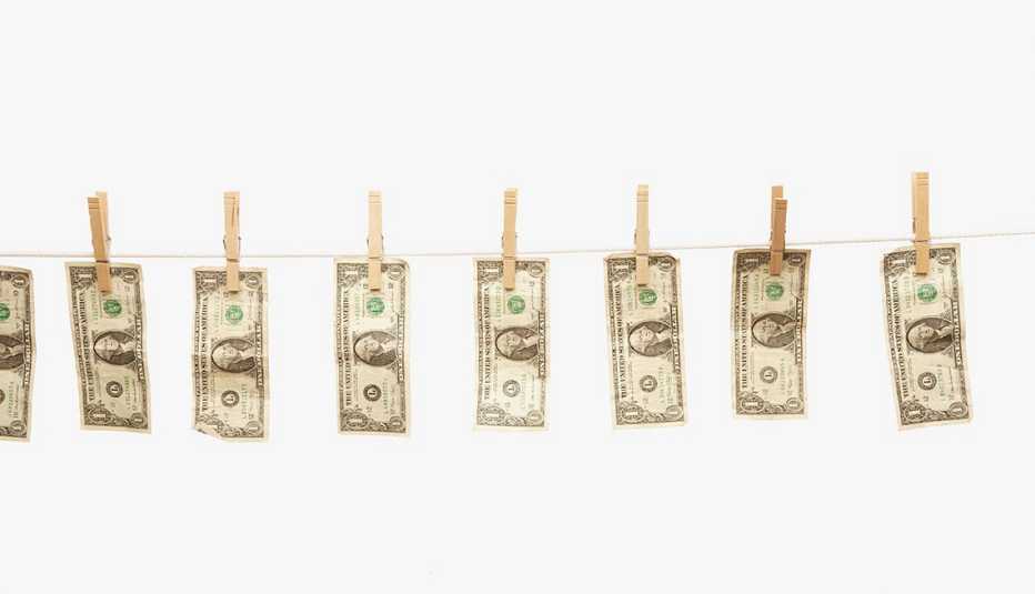 Dollar bills hanging on clothes line