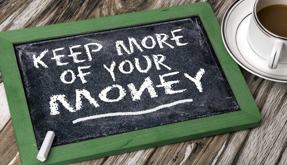 chalkboard sign on a table says keep more of your money