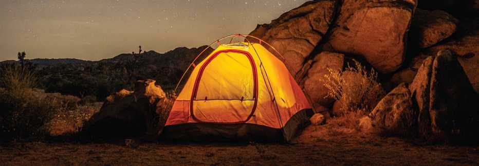 a tent illuminated at Joshua Tree National Park
