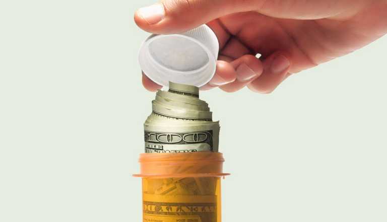 person placing a cap on a prescription medication bottle that is filled with a stack of rolled up hundred dollar bills