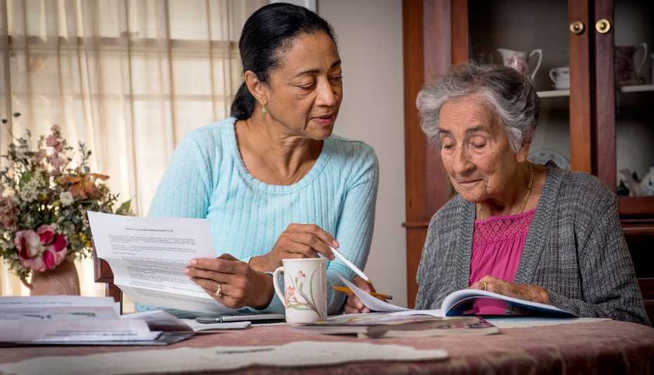 a caregiver helps a woman with her taxes
