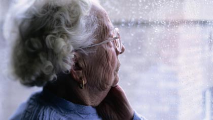 Elderly Woman Looking Out a Window