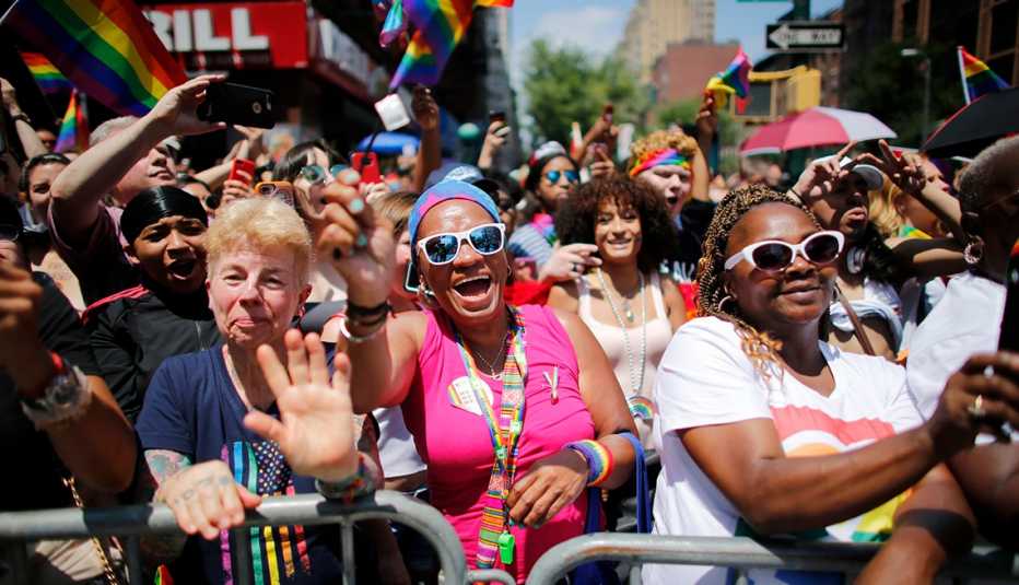 revellers watch the New York Pride Parade 