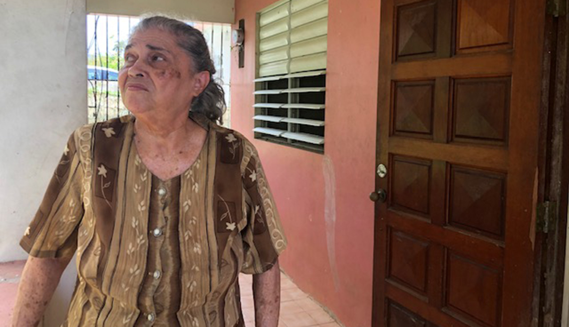 Hurricane survivor Nelida Castillo Cruz in front of her home