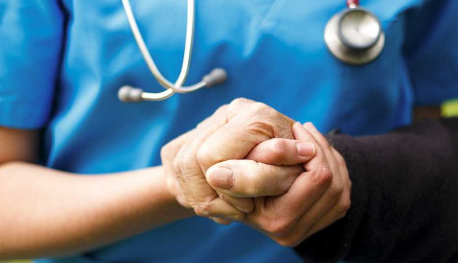 A doctor holding the hand of a patient