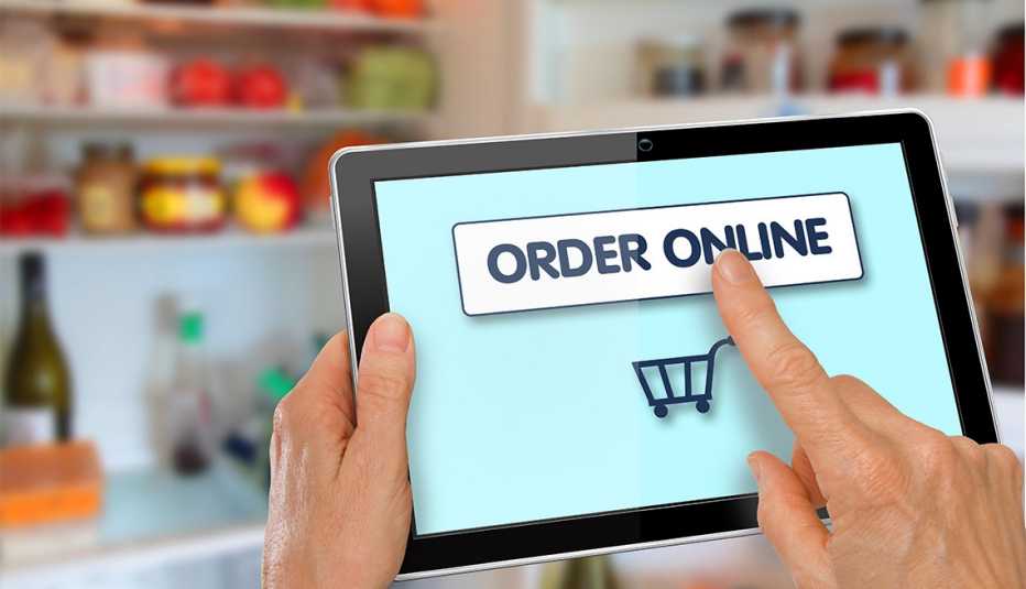 person using an tablet to start online grocery shopping