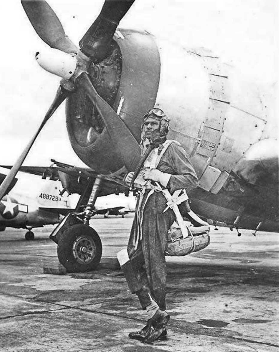 Pilot Harvey in front of a World War II-era P-47 Thunderbolt fighter plane 
